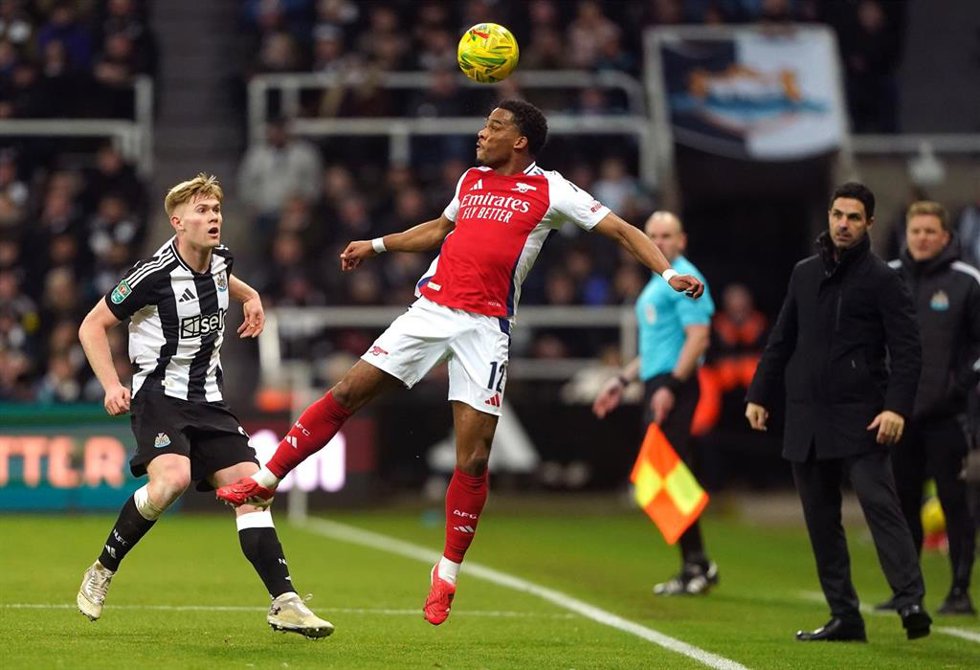 05 February 2025, United Kingdom, Newcastle Upon Tyne: Newcastle United's Lewis Hall (L) and Arsenal's Jurrien Timber battle for the ball during the English Carabao Cup Semi-Final, second leg soccer match between Newcastle United and Arsenal at St. Jame