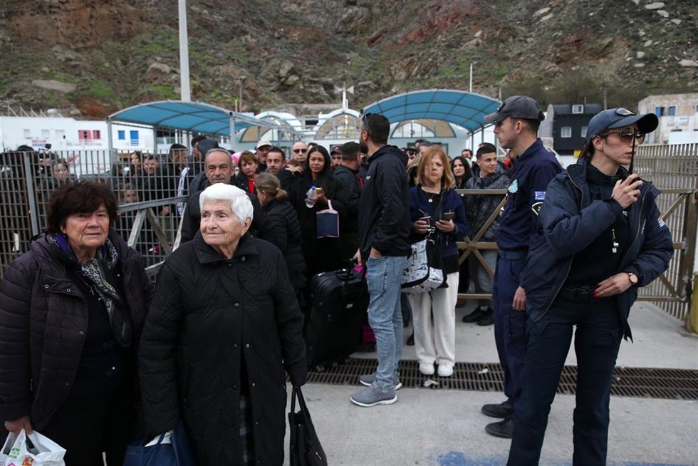 Un grupo de personas espera en Santorini para abandonar la isla en un ferry