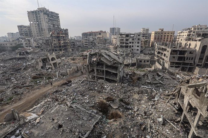 February 3, 2025, Gaza City, Gaza Strip, Palestinian Territory: Internally Palestinians walk along a street among the rubble of destroyed buildings amid a ceasefire between Israel and Hamas, in Gaza City, 03 February 2025. Israel and Hamas implemented the