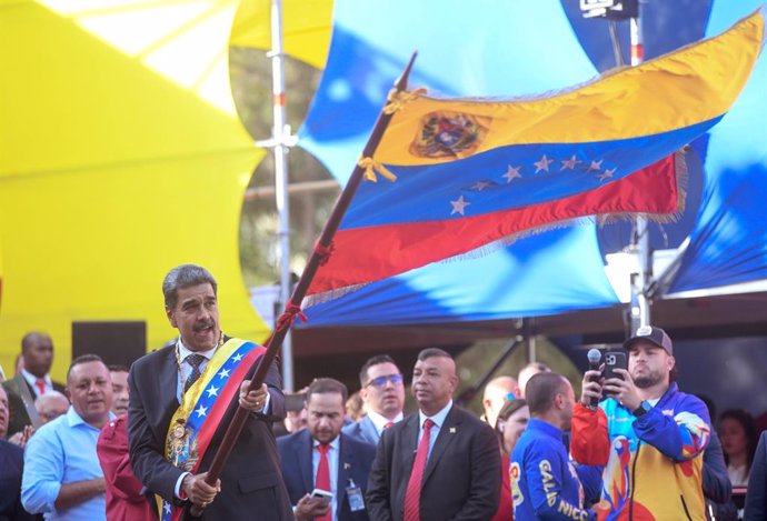 CARACAS, Jan. 11, 2025  -- Nicolas Maduro (front) waves a flag during a celebration rally after he was sworn in as Venezuelan president for a third term in Caracas, Venezuela, Jan. 10, 2025.   Nicolas Maduro on Friday was sworn in as Venezuelan president 