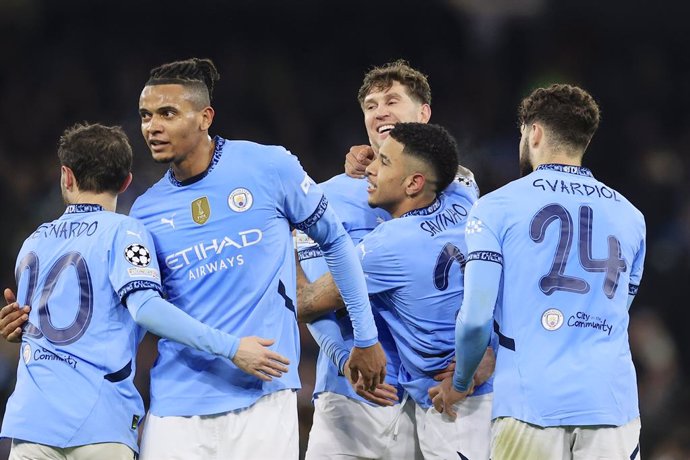 John Stones (5) of Manchester City congratulates Savinho (26) of Manchester City on scoring to make it 3-1 during the UEFA Champions League, League phase football match between Manchester City and Club Brugge on 29 January 2025 at the Etihad Stadium in Ma