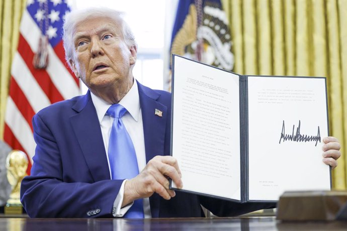 February 4, 2025, Washington, District Of Columbia, USA: US President Donald J. Trump holds up a newly signed executive order withdrawing the United States from the United Nations Human Rights Council in the Oval Office of the White House in Washington, D