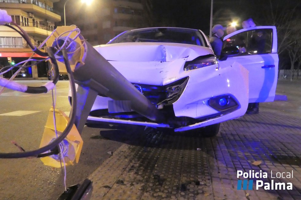 Coche accidentado en la calle Manacor con el semáforo empotrado en el parachoques.