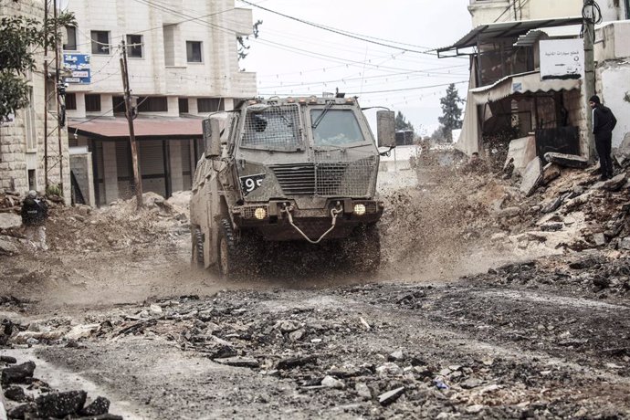 February 11, 2025, Jenin, West Bank, Palestine: An Israeli military vehicle drives through the middle of the destroyed market in the eastern neighborhood of the city of Jenin in the West Bank. The military operation launched by the Israeli army and air fo