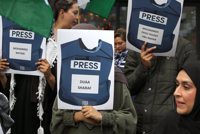 Archivo - October 19, 2024, Birmingham, UK: Protesters hold up up signs showing press vests with the names of Palestinians journalists who have lost their life during the last year of war during the demonstration. Protesters gather to march against the BB