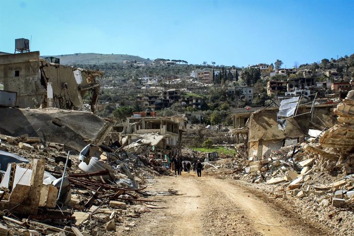 18 February 2025, Lebanon, Kfarkela: Lebanese villagers walk among debris and rubble of houses in the southern border village of Kfarkela after Israeli forces withdrew from border villages in southern Lebanon. Photo: Stringer/dpa