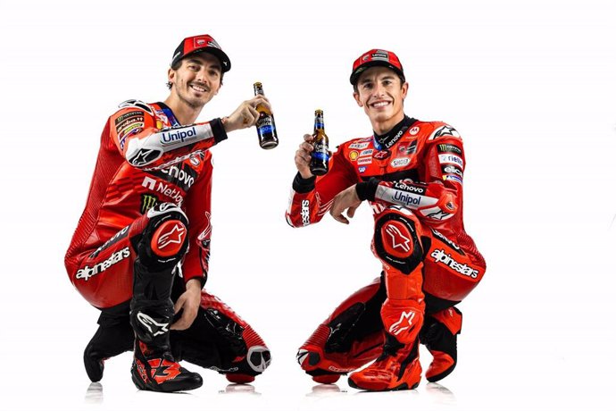 Los pilotos de MotoGP Francesco Bagnaia y Marc Márquez, del Ducati Corse, posando junto a dos cervezas de Estrella Galicia 0,0.