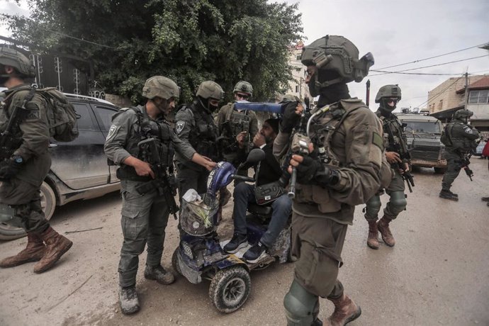 February 19, 2025, Jenin, West Bank, Palestine: Israeli soldiers prevent a Palestinian with special needs from entering the Jenin refugee camp near the West Bank city of Jenin. Israeli army forces prevented residents of the Jenin camp from returning to th