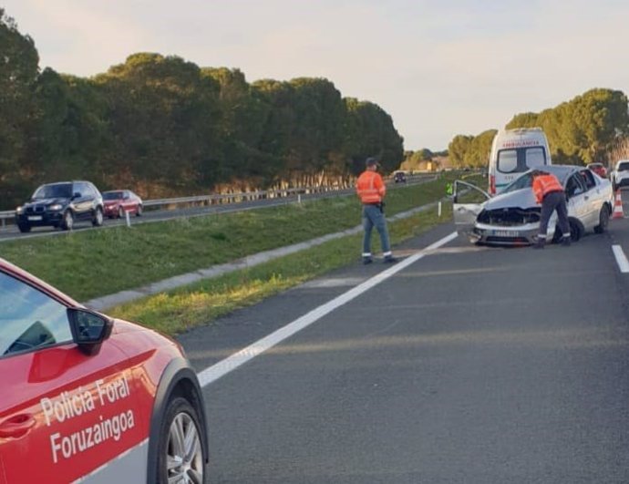 Agentes de la Policía Foral junto al vehículo accidentado.
