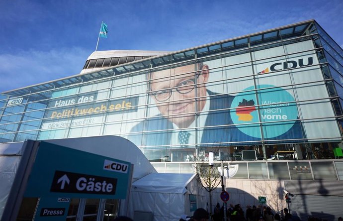 24 February 2025, Berlin: The portrait of Christian Democratic Union of Germany (CDU) federal chairman Merz can be seen on the facade of the Konrad Adenauer House. The committees of the federal parties meet for consultations after the election to the 21st