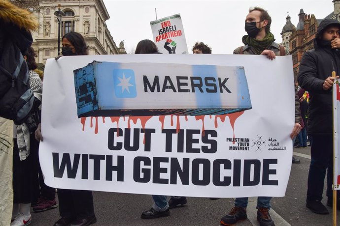 February 15, 2025, London, England, UK: Protesters hold a banner calling on Maersk to 'cut ties with genocide'. Thousands of protesters marched from Whitehall to the Embassy of USA in support of Palestine as the ceasefire between Israel and Hamas continue