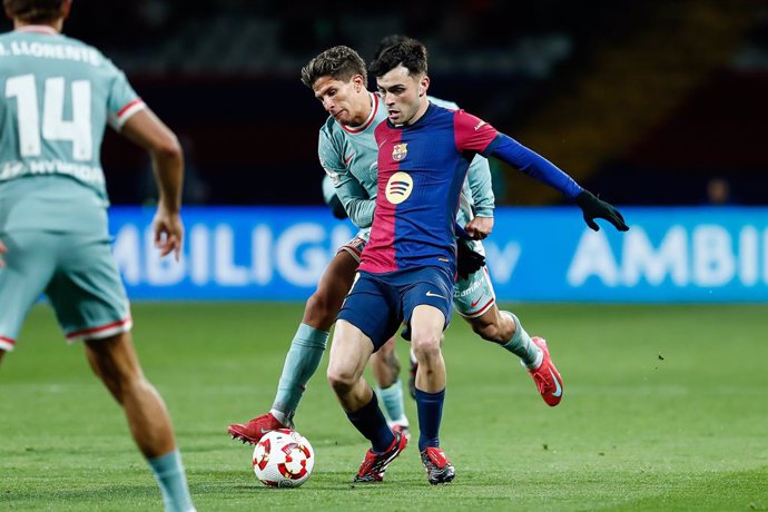 Giuliano Simeone of Atletico de Madrid and Pedri Gonzalez of FC Barcelona in action during the Spanish Cup, Copa del Rey, semi-final football match played between FC Barcelona and Atletico de Madrid at Estadi Olimpic Lluis Companys on February 25, 2025 in