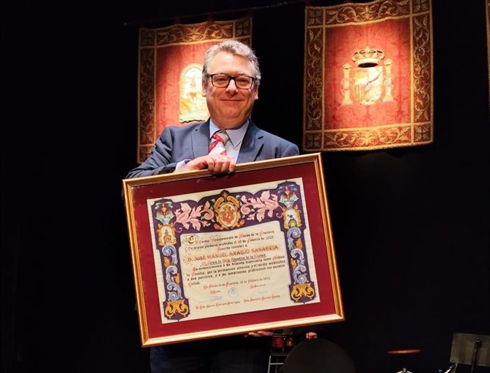 El médico en el centro de salud San Francisco de Morón de la Frontera recoge el título de Hijo Adoptivo de la localidad.