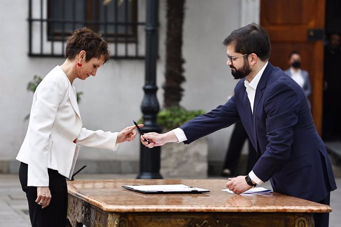 Archivo - 06 September 2022, Chile, Santiago: New Minister of the Interior Carolina Toha (L) signs before Chilean President Gabriel Boric to take office. Boric ordered a cabinet reform after the constitutional proposal submitted last Sunday to a plebiscit