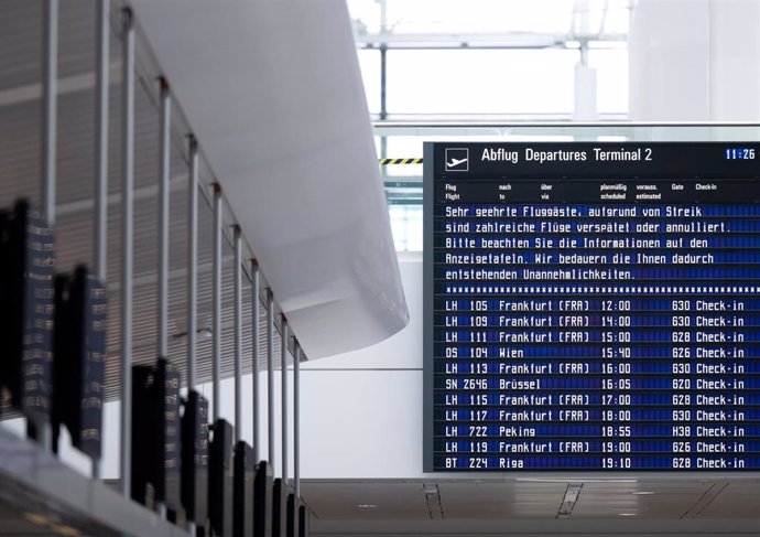 A display board at Munich Airport shows information about the strike and flights. 