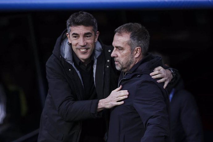 Hansi Flick, head coach of FC Barcelona greets Bruno Lage, head coach of SL Benfica during the UEFA Champions League 2024/25 Round of 16 second leg, match between FC Barcelona and SL Benfica at Estadi Olimpic Lluis Companys