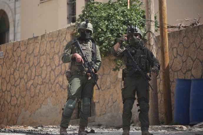 March 4, 2025, Jenin, West Bank, Palestinian Territory: Israeli army armoured vehicles are stationed on a side street during a raid in the eastern neighbourhood of Jenin amid a weeks-long offensive in the occupied West Bank on March 4, 2025