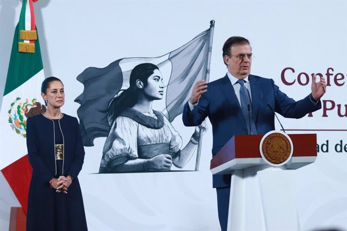 Mexico's President Claudia Sheinbaum is seen behind while  Marcelo Ebrard Casaubon, Secretary of Economy speaking about the agreement the president reached with President Trump, that exports that comply with T-MEC provisions will not be subject to tariffs