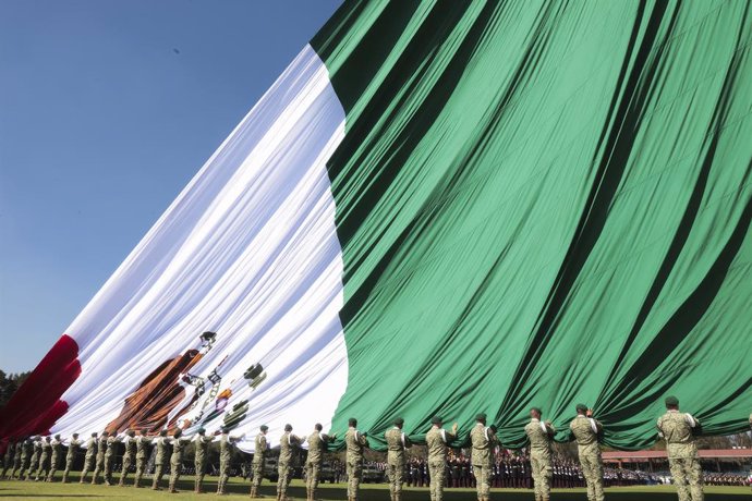 February 24, 2025, Mexico City, Df, Mexico: Mexican soldiers unveil a massive Mexican flag during Flag Day celebrations at Campo Marte, February 24, 2025 in Mexico City, DF, Mexico.