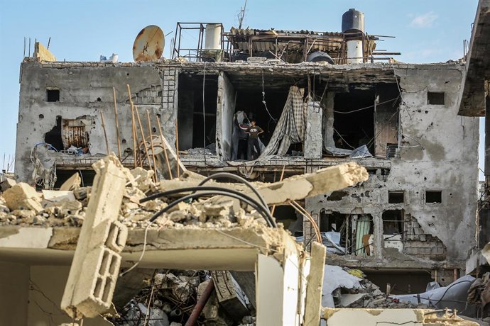 Palestinos em um prédio destruído em Khan Younis como resultado do bombardeio do exército israelense na Faixa de Gaza.