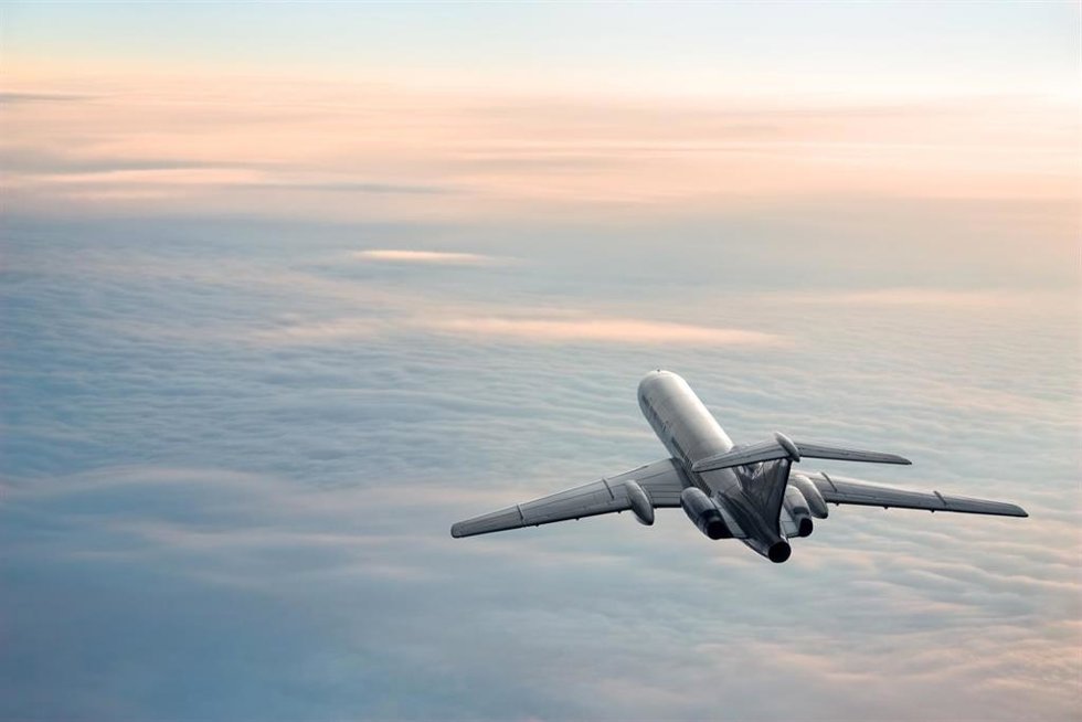 Archivo - Passenger aircraft on the clouds background. Daybreak flight in stratosphere. Pastel colored image.
