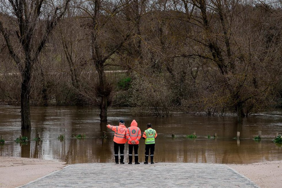 Tres agentes del SAMUR observan el parking de Somontes inundado, a 21 de marzo de 2025, en Madrid (España).