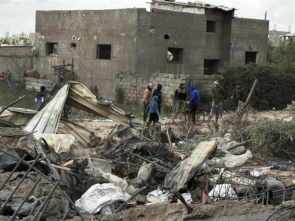  Vista de edificios residenciales destruidos y vehículos destrozados en Jan Yunis
