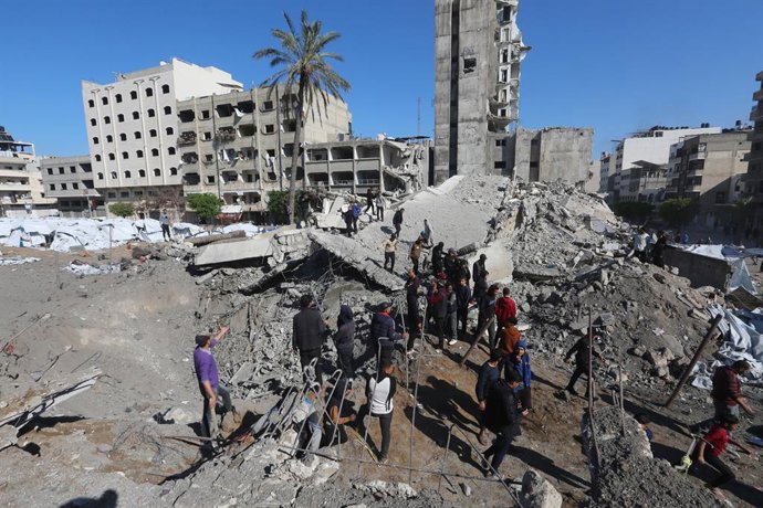 23 de março de 2025, Cidade de Gaza, Faixa de Gaza, Território Palestino: Palestinos inspecionam uma cratera no local dos ataques israelenses em um campo de deslocamento improvisado no centro da Cidade de Gaza em 23 de março de 2025