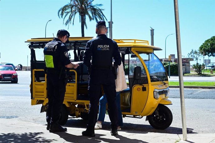 Agentes de Policía Local, junto a un 'tuk tuk'.