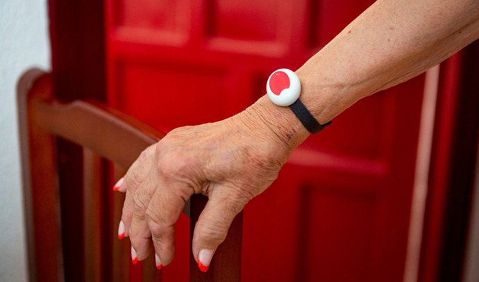Usuaria portando la pulsera con el botón rojo que conecta directamente con el Servicio Andaluz de Teleasistencia.