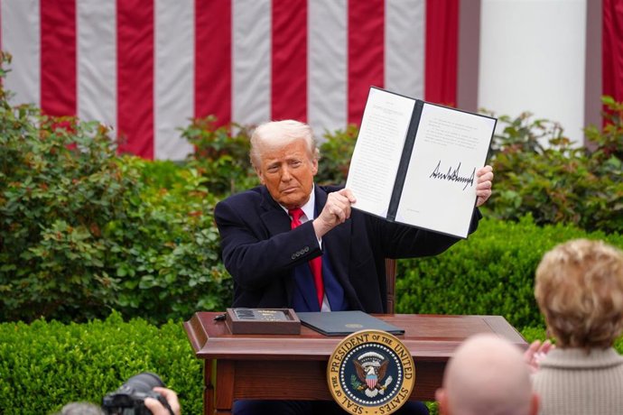 April 2, 2025, Washington, District Of Columbia, USA: US President DONALD TRUMP holds up a signed executive order implementing new reciprocal tariffs against US trading partners in the Rose Garden of the White House in Washington. Trump has branded the da