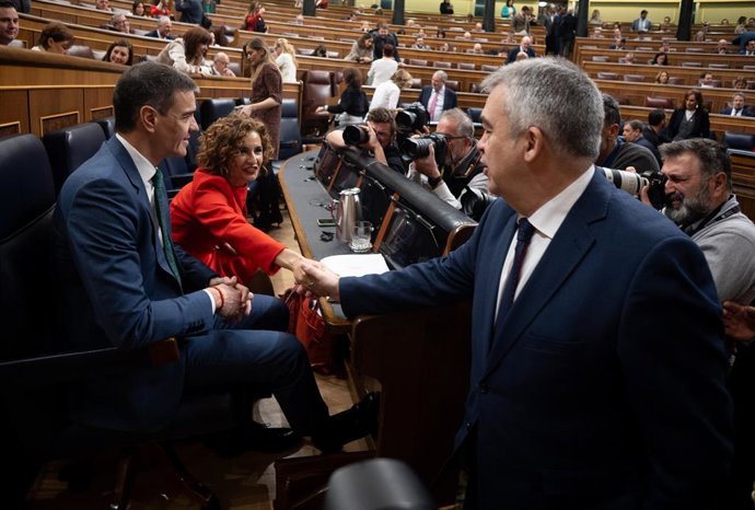 O Presidente do Governo, Pedro Sánchez, e a Primeira Vice-Presidente e Ministra da Fazenda, María Jesús Montero, que cumprimenta o Secretário de Organização do PSOE, Santos Cerdán, durante uma sessão plenária no Congresso dos Deputados, em 26 de março.