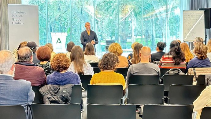 Eduardo Lucena (al fondo) da la bienvenida a los bibliotecarios reunidos en la Biblioteca Grupo Cántico.