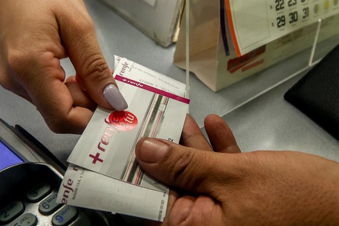 Archivo - Un viajero carga su tarjeta Renfe con el nuevo abono gratuito