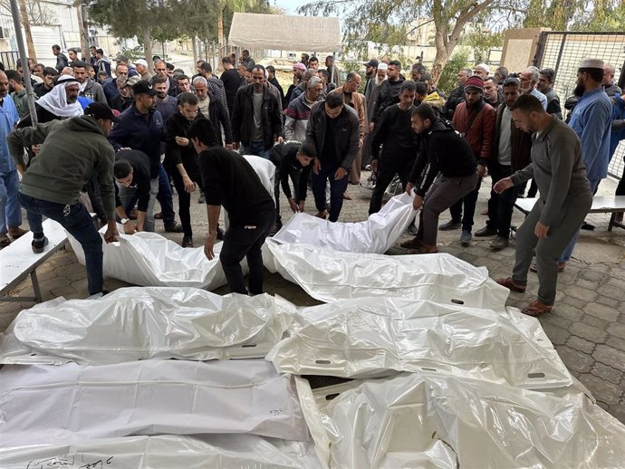 Palestinos juntos a varios muertos por un ataque del Ejército de Israel contra tiendas de campaña usadas por desplazados en la ciudad de Jan Yunis, en el sur de la Franja de Gaza (archivo)