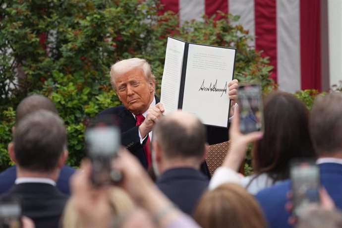 President Donald J Trump displays the signed Executive Order after concluding his remarks during a 'Make America Wealthy Again' event in the Rose Garden of the White House in Washington, DC on Wednesday, April 2, 2025. 