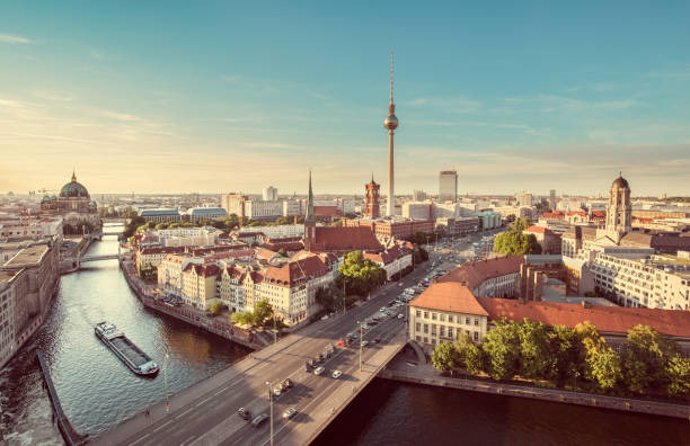 Aerial view of Berlin skyline with famous TV tower and Spree river in beautiful evening light at sunset with retro vintage Instagram style grunge pastel toned filter effect, Germany