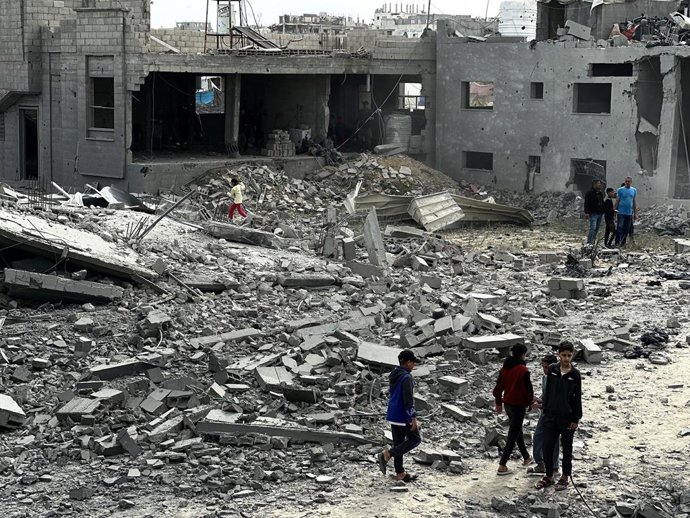 13 de abril de 2025, Khan Yunis, Faixa de Gaza, Território Palestino: Palestinos inspecionam o local de um ataque israelense a tendas e edifícios que abrigam pessoas deslocadas, em Khan Younis, no sul da Faixa de Gaza, em 13 de abril de 2025