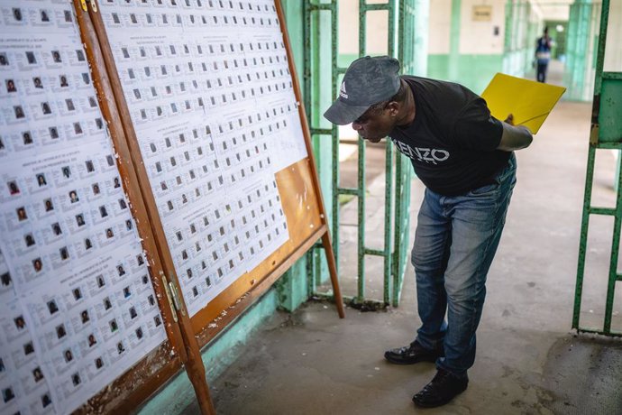 LIBREVILLE, April 11, 2025  -- A man checks the voters' information at a polling station in Libreville, Gabon, on April 11, 2025. Gabon will hold its first presidential election on Saturday since a coup two years ago, marking the final phase of the countr