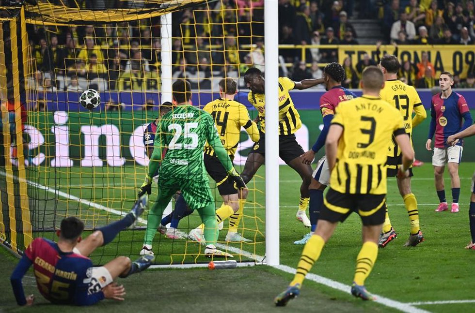 Dortmund's Serhou Guirassy (C) scores his side's second goal during the UEFA Champions League quarter-final second leg soccer match between Borussia Dortmund and FC Barcelona at the Signal Iduna Park