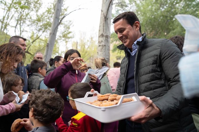 El presidente de la Diputación de Almería, Javier Aureliano García, reparte unos roscos entre niños en el área recreativa 'El Nacimiento' de Laujar de Andarax (Almería).