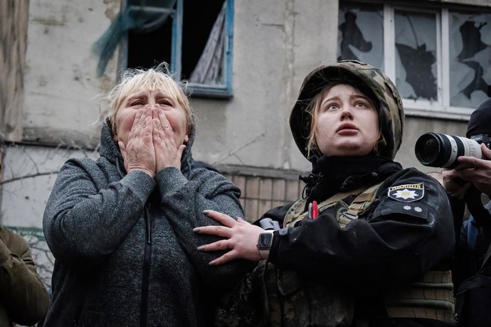 Archivo - Arquivo - 14 de abril de 2023, Sloviansk, Ucrânia: Uma moradora reage ao lado de uma policial enquanto aguardam a equipe de resgate chegar aos membros de sua família nos escombros em Sloviansk. Tropas russas atacaram a cidade de Sloviansk, no le