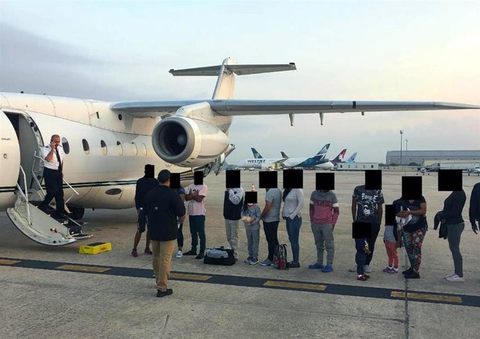 Archivo - Migrantes, con los rostros cubiertos, fuera de un avión de deportación de Estados Unidos  (archivo)
