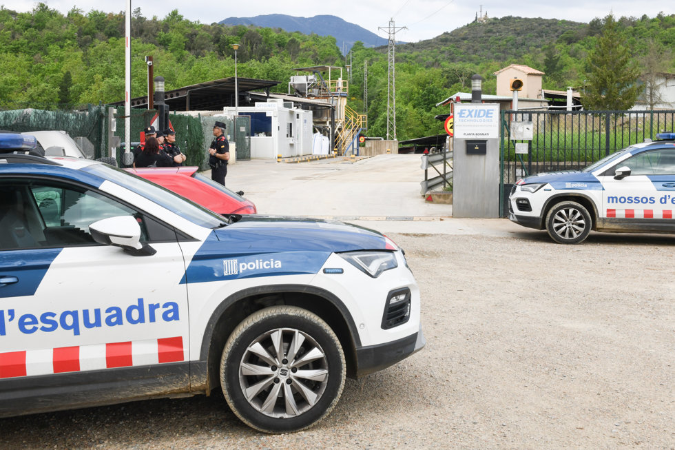 Coches y agentes de los Mossos delante de la planta de reciclaje de baterías donde ha habido la explosión en Sant Juli de Llor i Bonmatí (Girona)