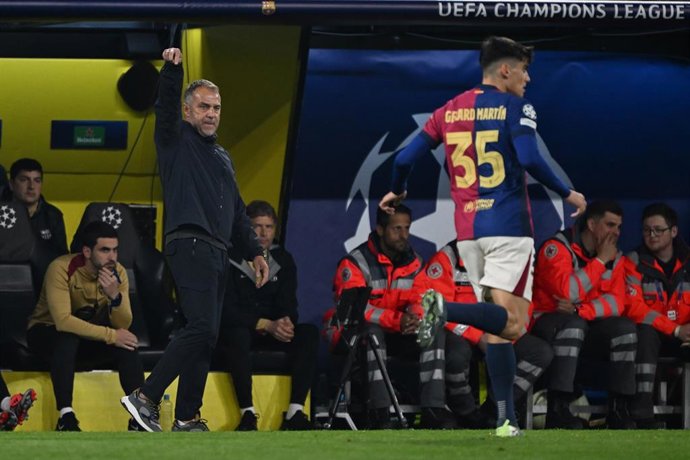 Barcelona coach Hansi Flick (L) gestures on the sidelines during the UEFA Champions League quarter-final second leg soccer match between Borussia Dortmund and FC Barcelona at the Signal Iduna Park