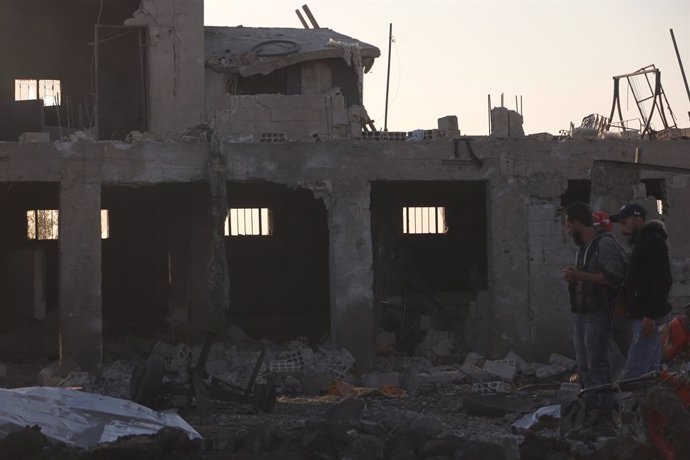 SWEIDA (SYRIA), May 2, 2025  -- People are seen in front of a building destroyed in a suspected Israeli drone strike in Sweida, southern Syria, on May 2, 2025. An airstrike targeted a site west of the southern Syrian province of Sweida on Friday, killing 