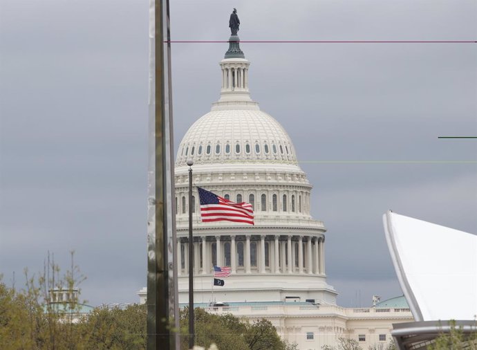 April 12, 2025, Washington Dc, Virginia, USA: A U.S. flag waves in front of the U.S. Capitol on a windy day in Washington, DC, on April 12, 2025.