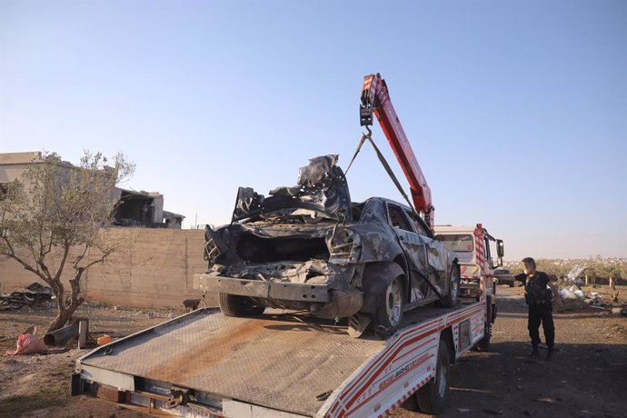 SWEIDA (SYRIA), May 2, 2025  -- A vehicle destroyed in a suspected Israeli drone strike is lifted onto a truck in Sweida, southern Syria, on May 2, 2025. An airstrike targeted a site west of the southern Syrian province of Sweida on Friday, killing three 