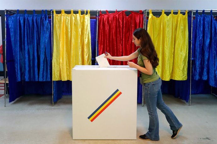 BUCHAREST, May 4, 2025  -- A woman votes during the first round of the presidential election rerun at a polling station in Bucharest, Romania, May 4, 2025. Romanians headed to the polls on Sunday for the first round of the presidential election rerun cont