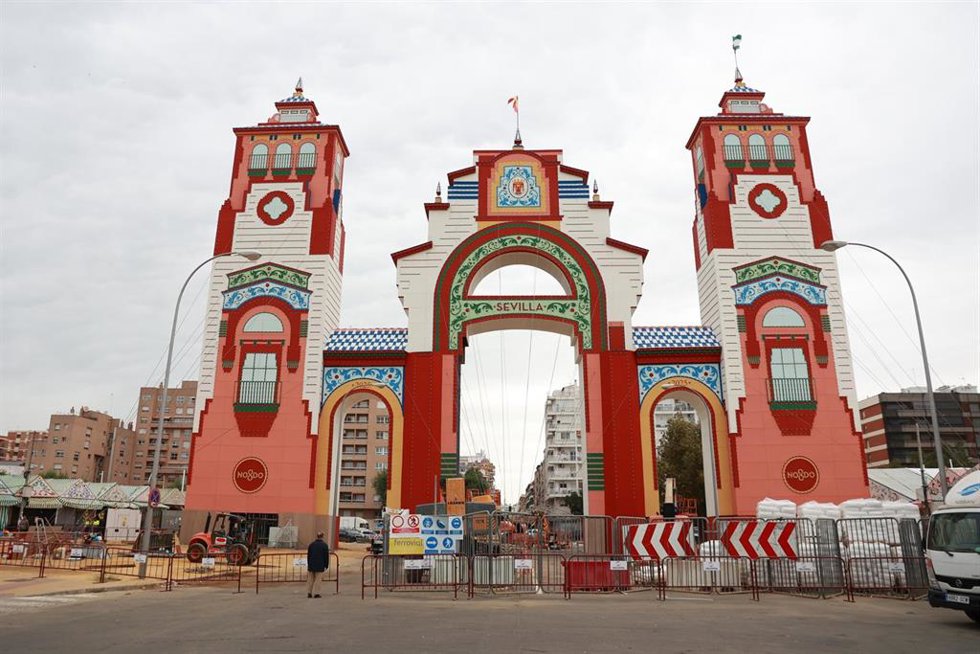 Varios trabajadores ultiman las tareas de montaje de la portada de la Feria de Sevilla.